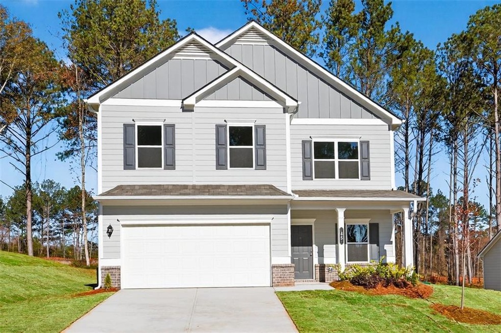 Craftsman inspired home with board and batten siding and a front lawn