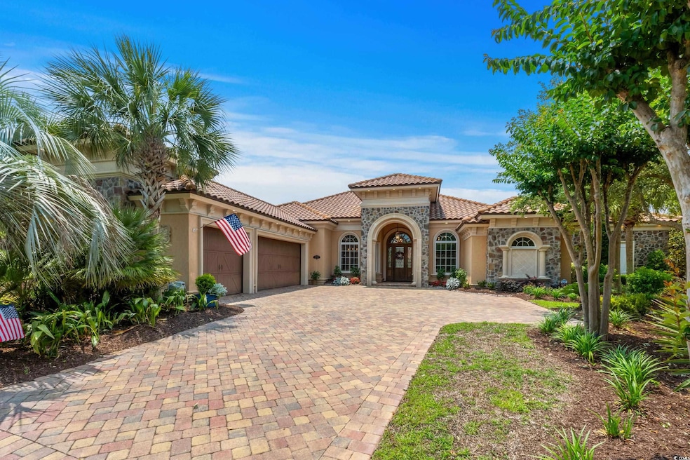 Mediterranean / spanish-style house with stucco siding, an attached garage, decorative driveway, a tiled roof, and stone siding