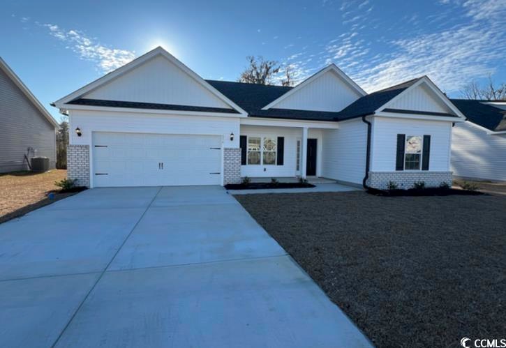 View of front of property with a garage and centra