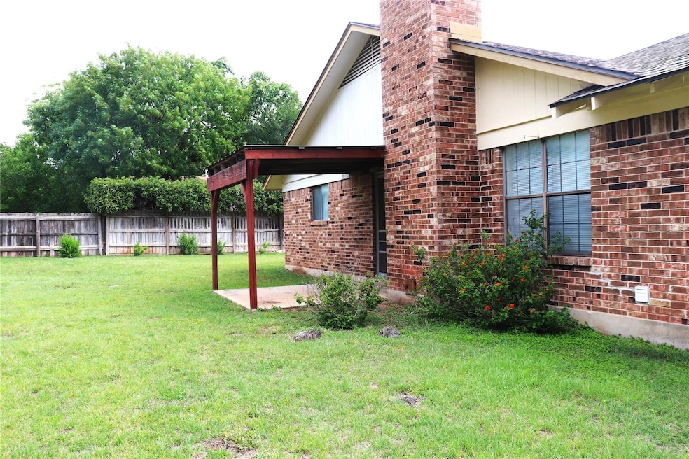 View of yard featuring a patio and fence
