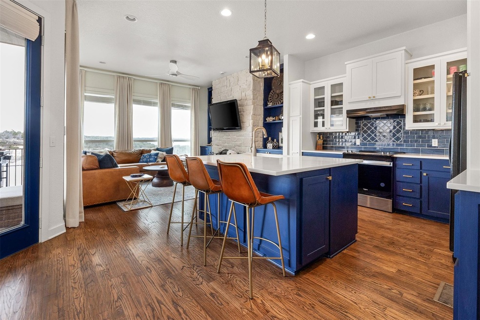 Kitchen featuring under cabinet range hood, electr