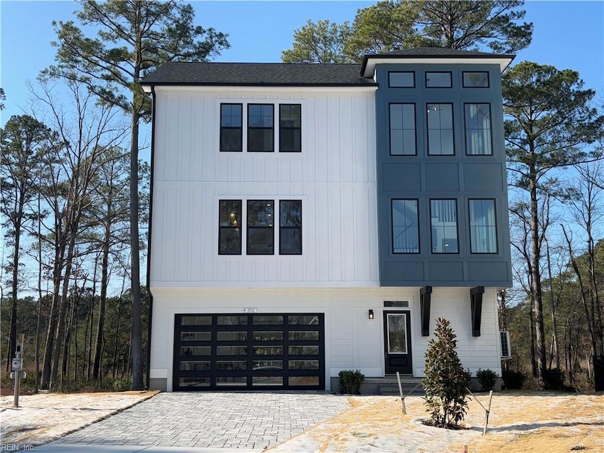 Welcome to Amavida waterfront home w/glass front and rear garage doors