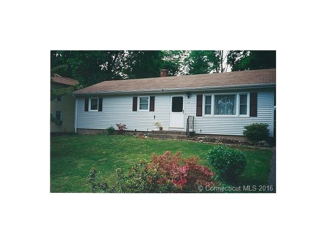 Older springtime photo of front with green grass.