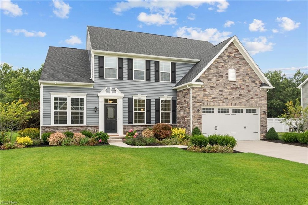 View of front facade with garage and a front yard