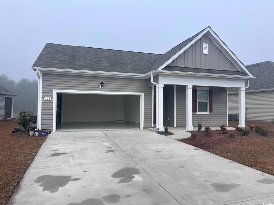 View of front of house with a porch and a garage