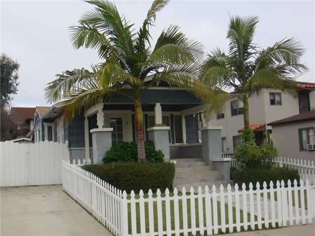 Front of home, with white picket fence and elegant