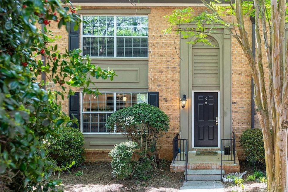 Entrance to property featuring brick siding