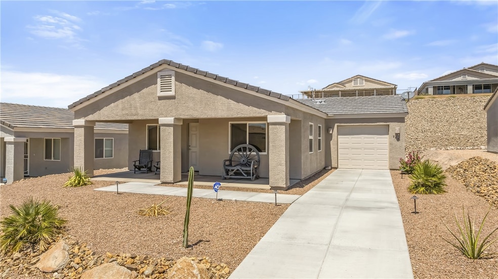 Ranch-style house featuring stucco siding, concrete driveway, a tile roof, and an attached garage