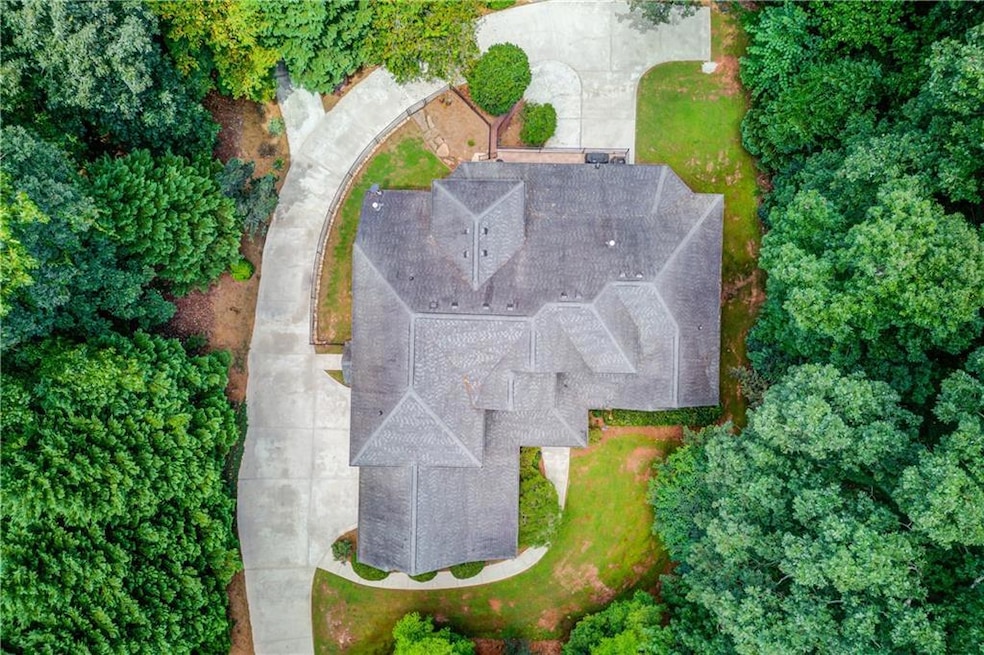 Aerial view shows the drive around to the terrace level and also a poured parking pad