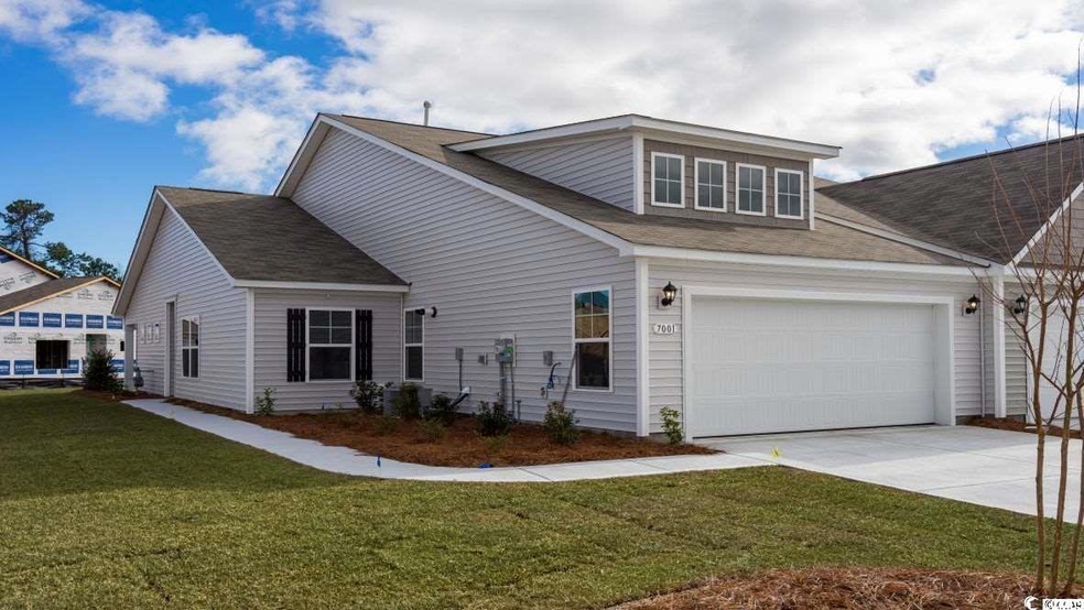 View of front facade with concrete driveway, a front lawn, and an attached garage