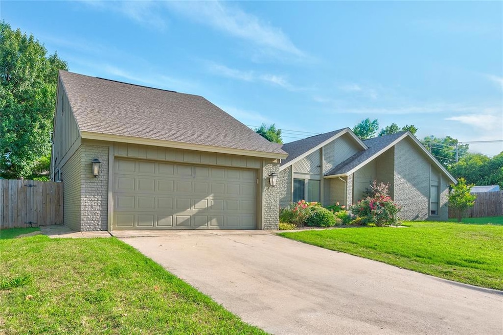 View of front of home featuring brick siding, concrete driveway, roof with shingles, and a garage