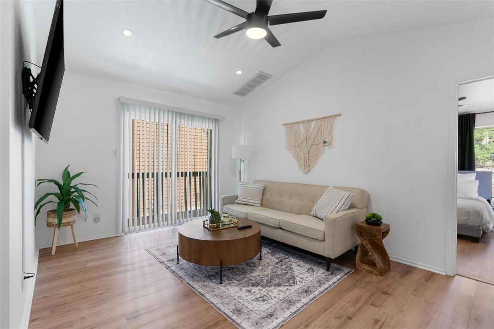 Living area with ceiling fan, light wood finished
