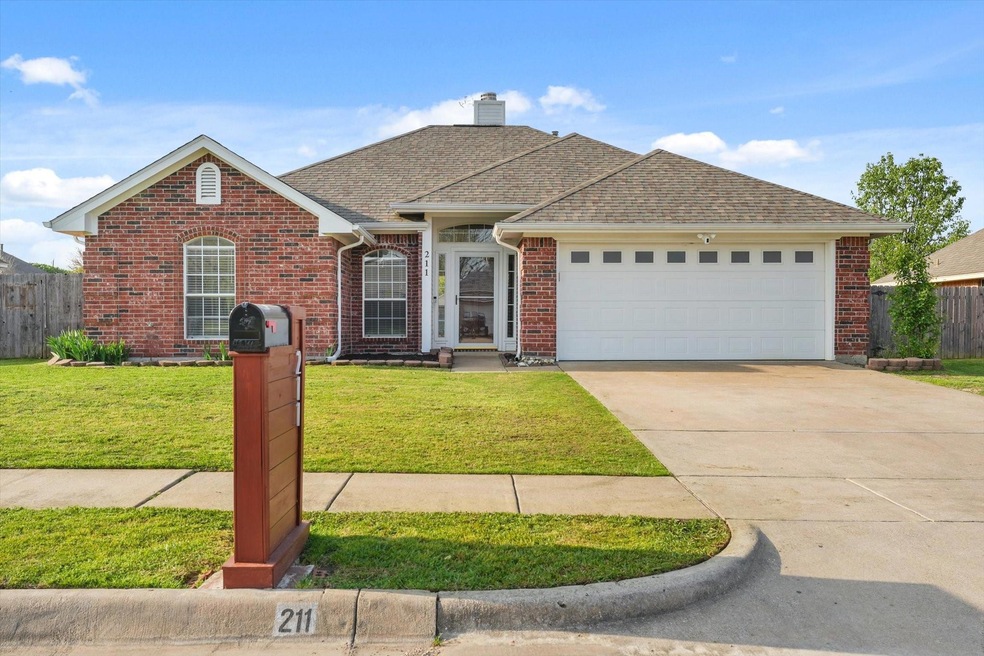 Ranch-style house with brick siding, fence, a front lawn, and a garage