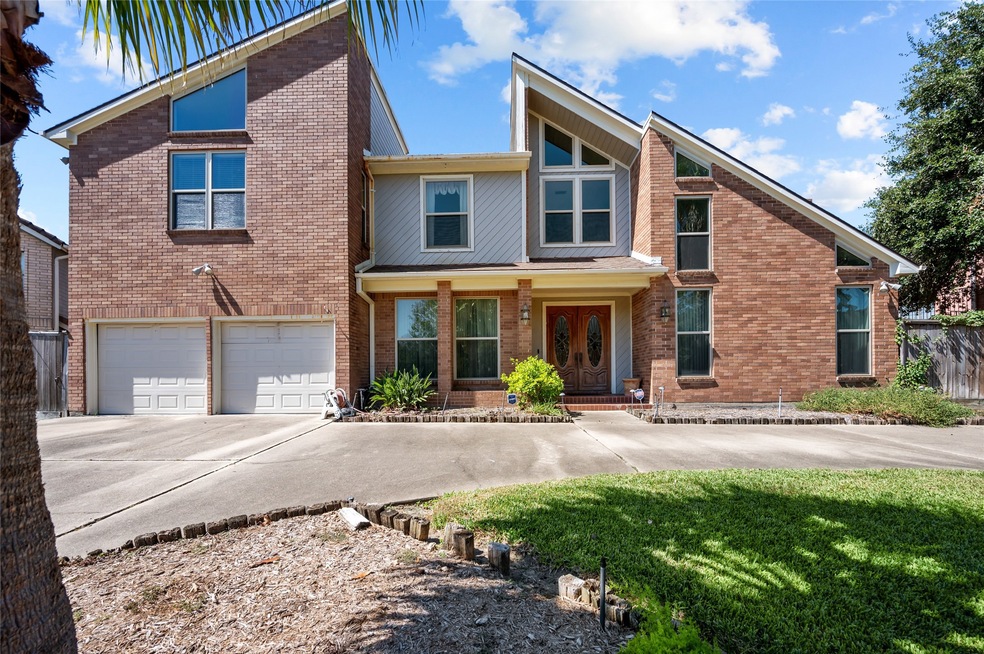 This is a two-story brick home with a two-car gara