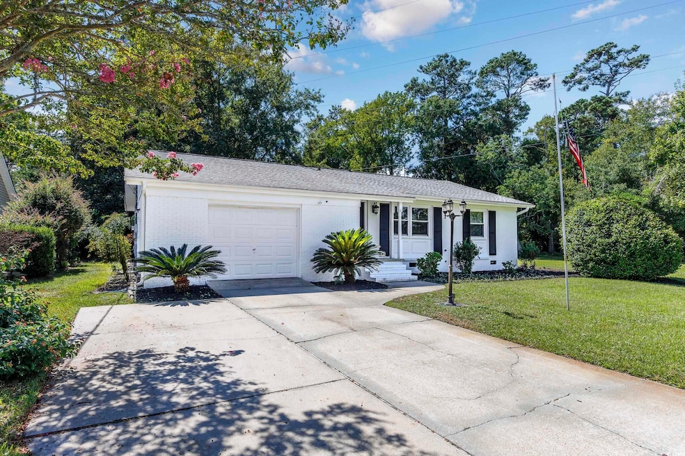 Single story home featuring a garage and a front y