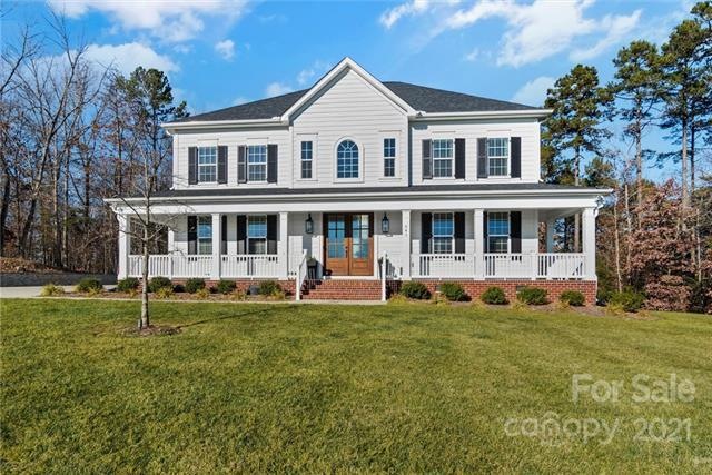 Come home to this white home set on a hill.