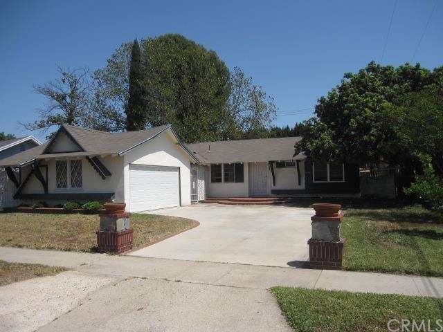 Front of House with Hardscape Porch and Post on Driveway
