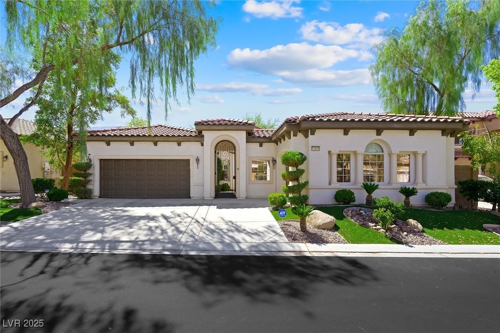 Mediterranean / spanish house with a garage, stucco siding, concrete driveway, and a tile roof