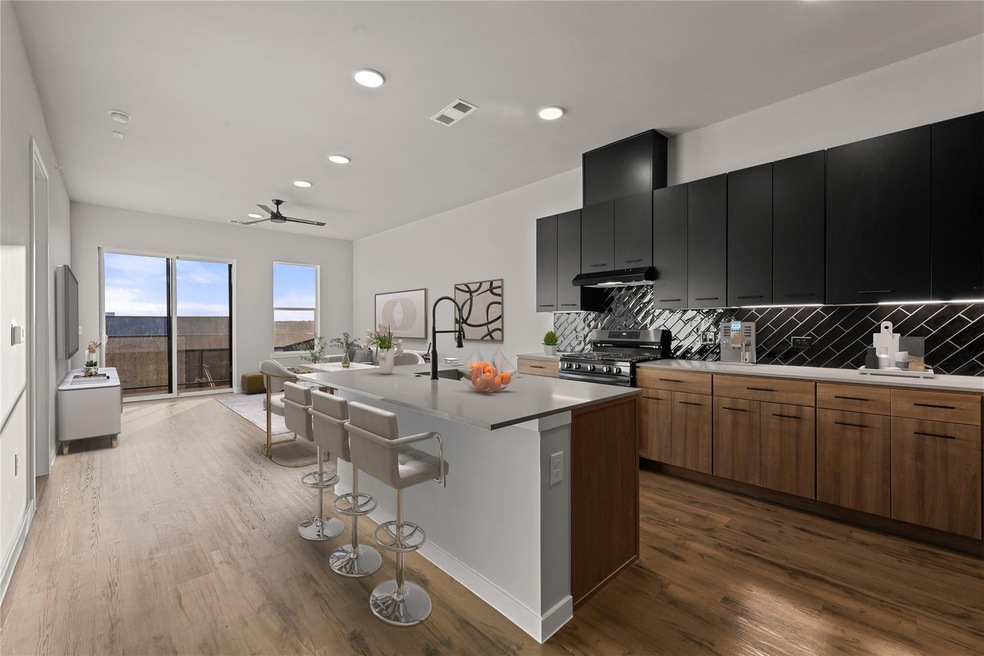 Kitchen featuring stainless steel gas range oven,