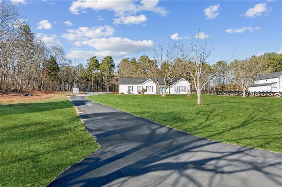 Ranch-style house featuring a front lawn and driveway