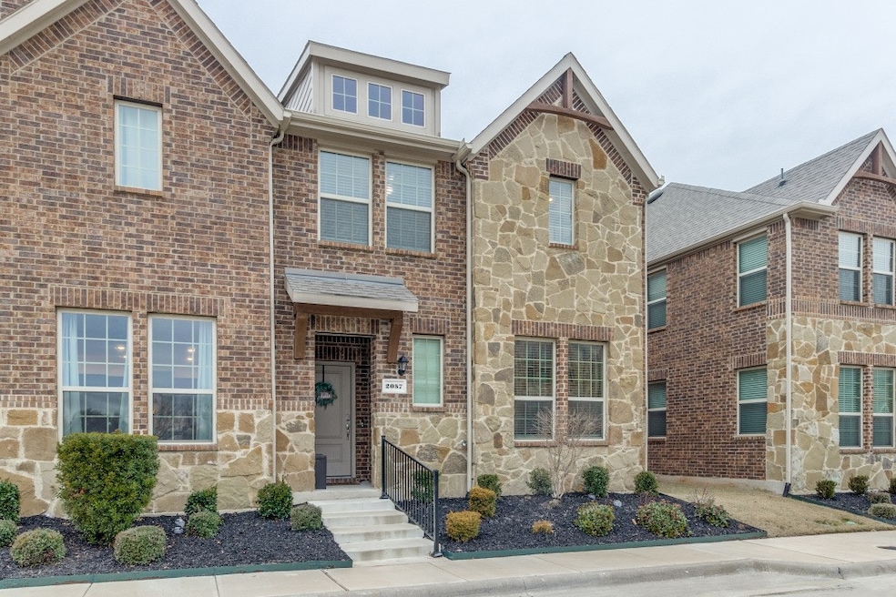 View of front facade featuring stone siding and brick siding
