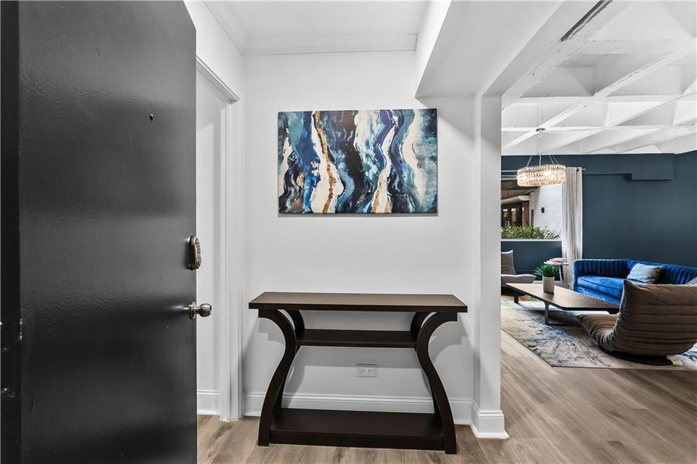 Hall featuring light wood-type flooring and baseboards