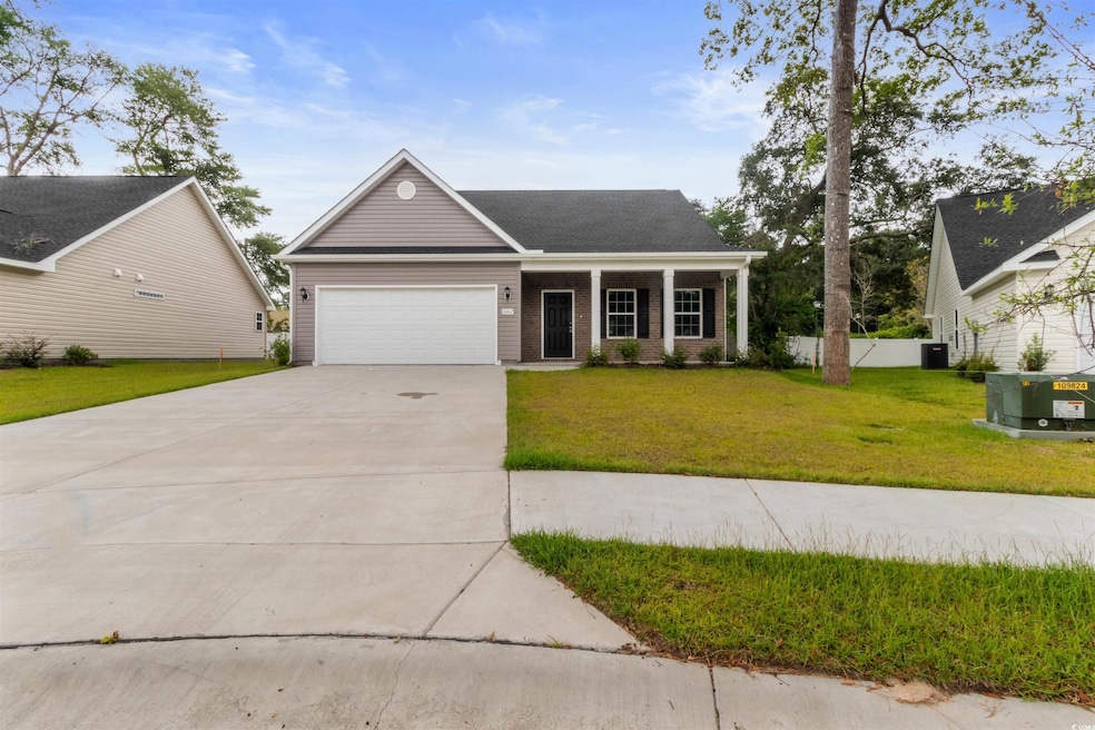 View of front of home with a garage and a front lawn