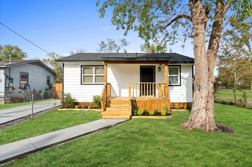 Front view of the home, porch, landscaping and yar