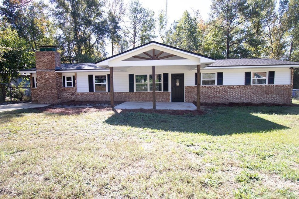 Ranch-style house with a front lawn