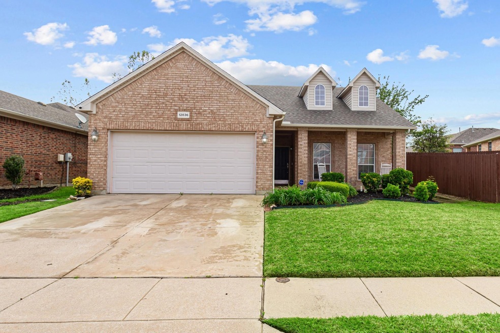 View of front of home with a front yard and a gara