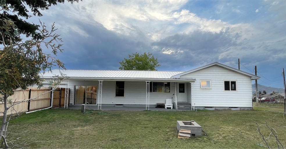 Rear view of house featuring a metal roof