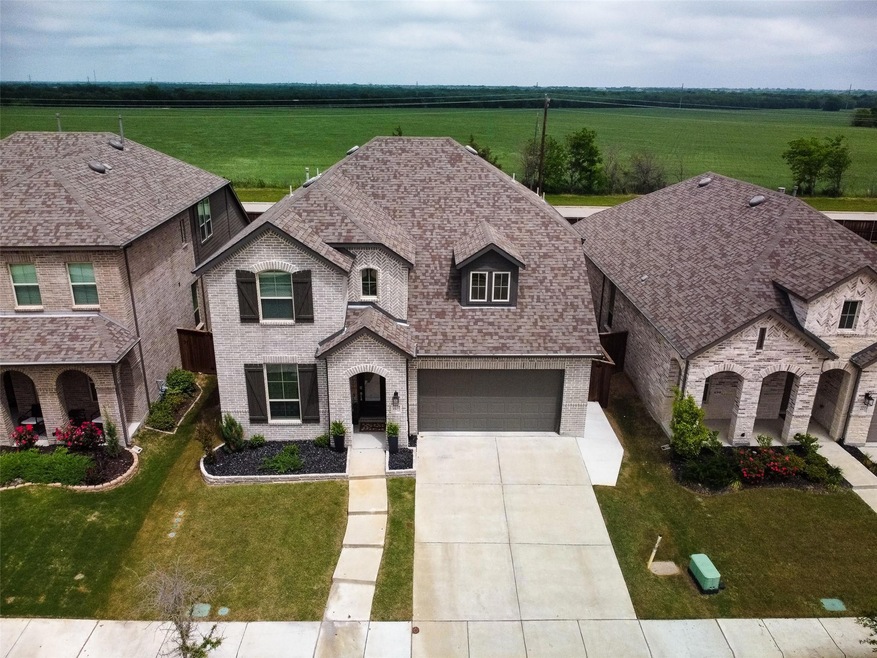French provincial home with a front yard and a garage