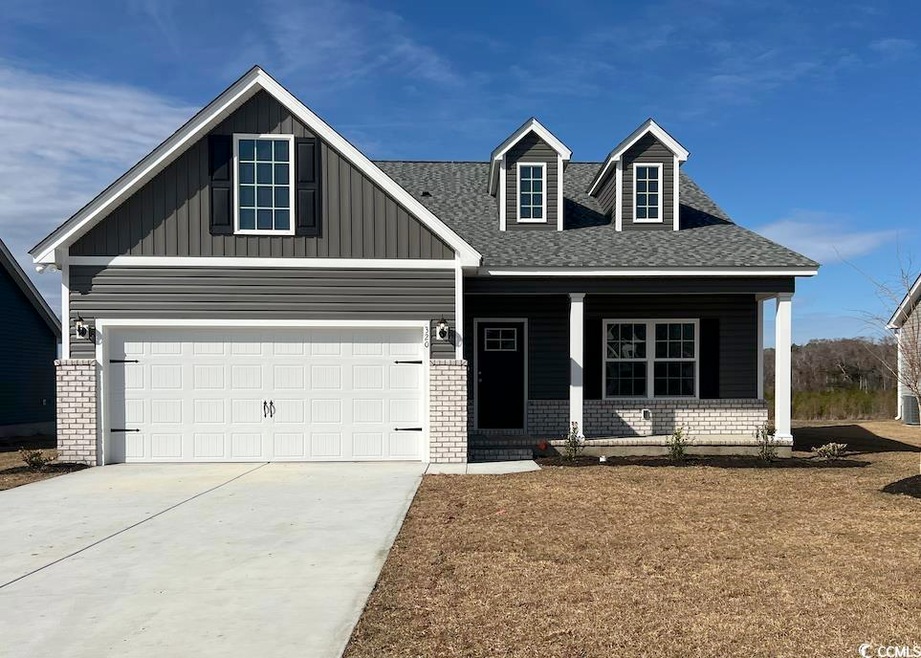 View of front of property with a garage and covere