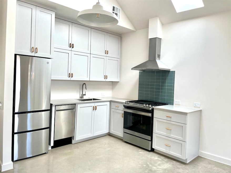 Kitchen with stainless steel appliances, wall chi