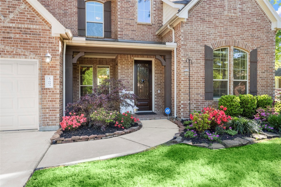 Every perfectly designed detail in this home screams elegance!  The handsome, wrought-iron enhanced glass and solid wood front door is surrounded by the extremely impressive double paned, brick-lined windows.  The arched board and batten shutters contrast perfectly against the brick façade, while the stain of the porch entrance beams is a perfect match to those BnB shutters.