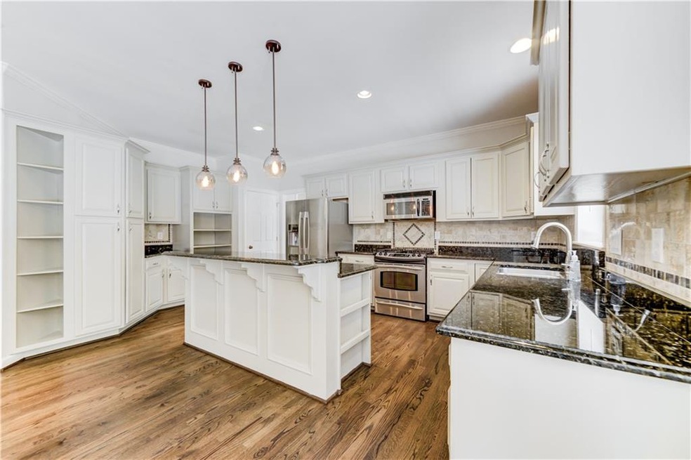Gleaming granite counter tops and center island cr
