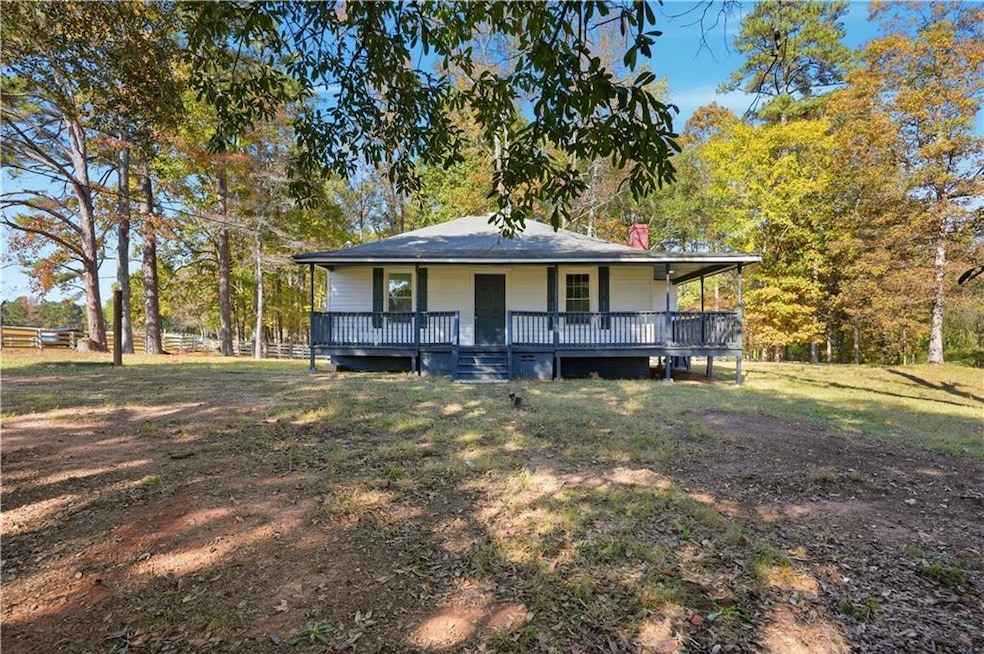 Farmhouse-style home with a porch, a front lawn, and a chimney