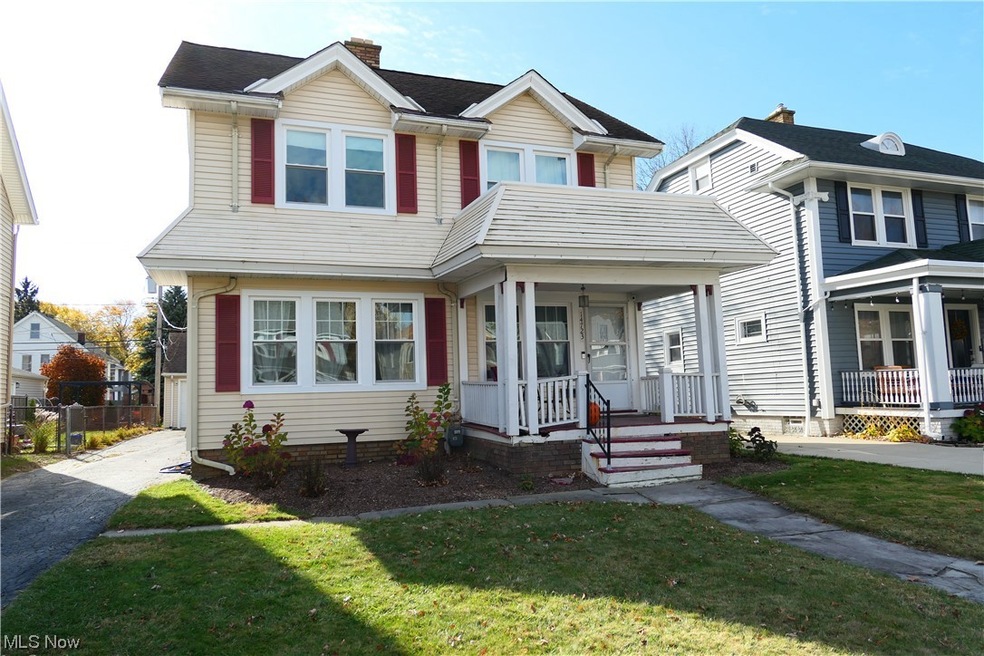 View of front of house with a front yard and covered porch