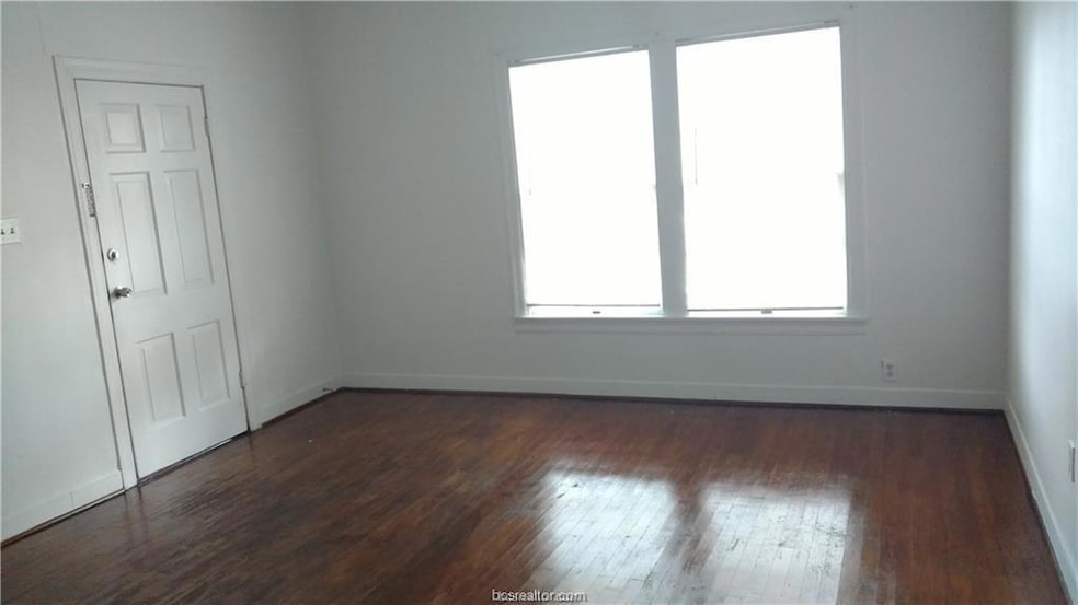 Unfurnished room featuring dark wood-style floorin