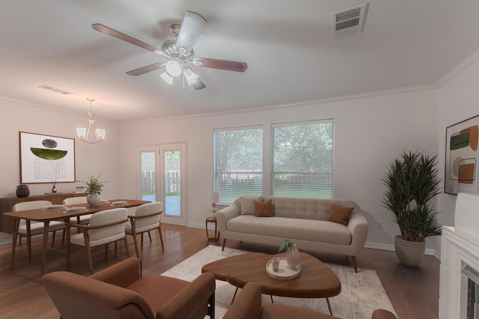 Living area with ornamental molding, ceiling fan,