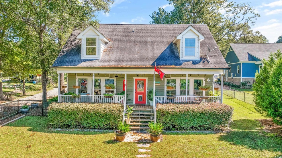Cape cod house with a front lawn and a porch