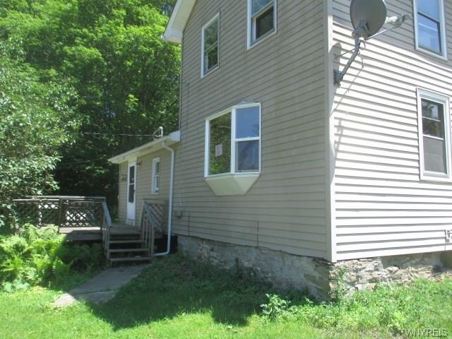 FRONT VIEW, DECK AND BAY WINDOW