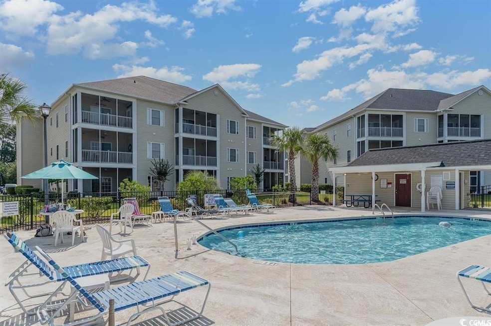 Community pool with fence and a patio area