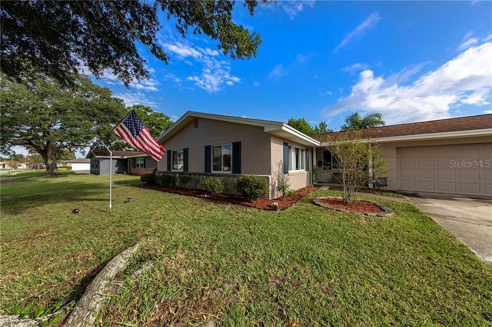SOLID BLOCK construction WITH BRICK trim - NEW EXTERIOR PAINT - established easy care landscaping.
