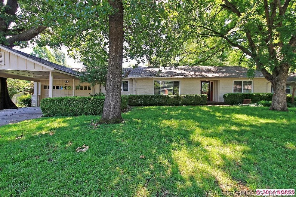 One story stone home has a two car garage plus a c