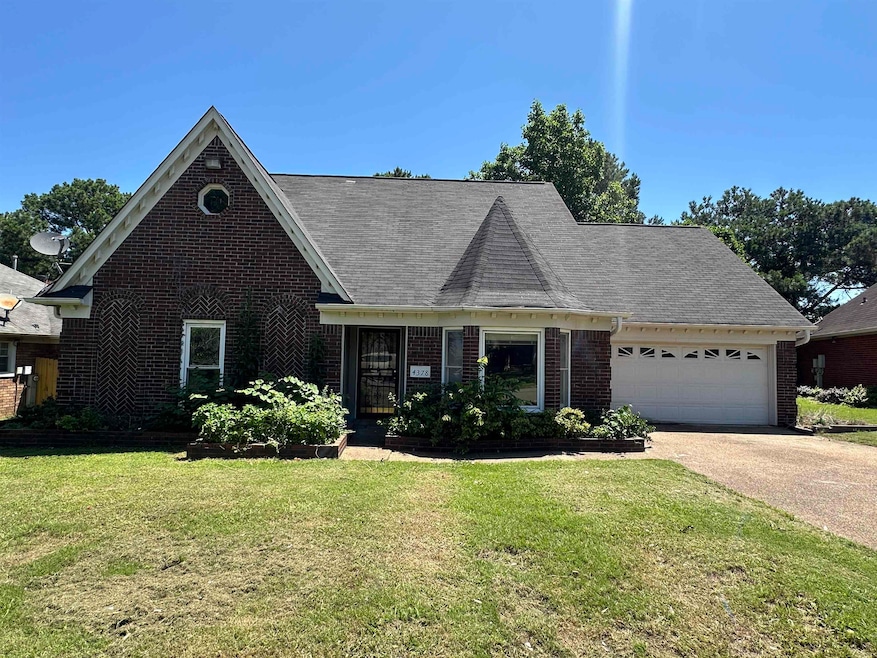 View of front of home with brick siding, a garage, driveway, a front lawn, and roof with shingles