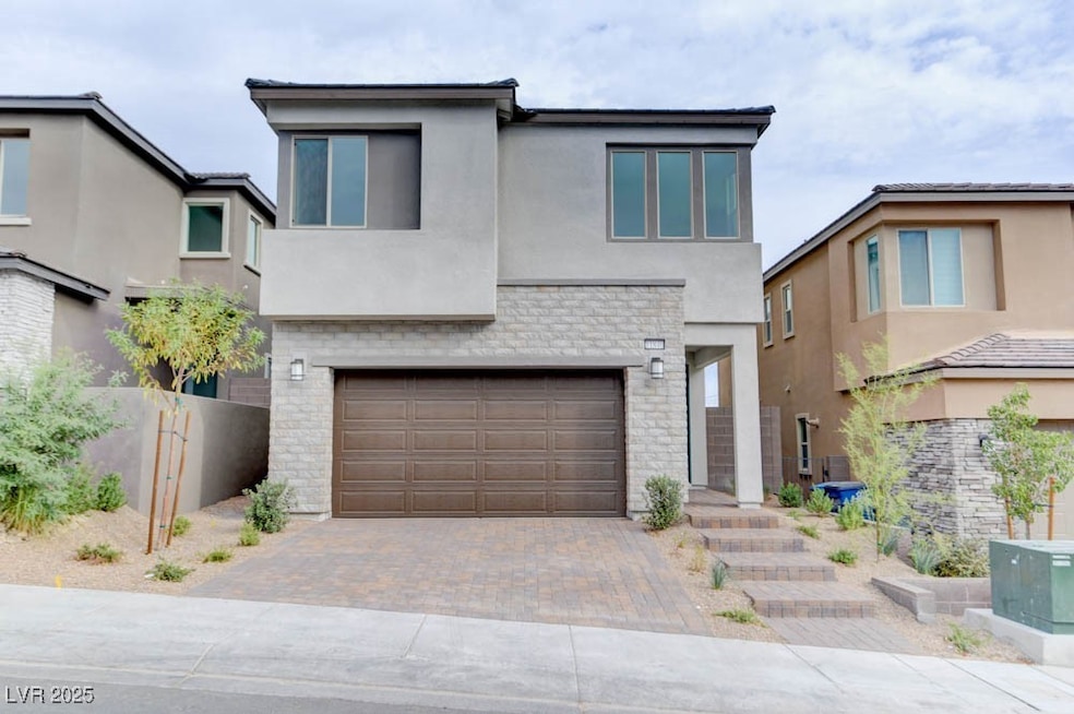 Contemporary home featuring stucco siding, decorat