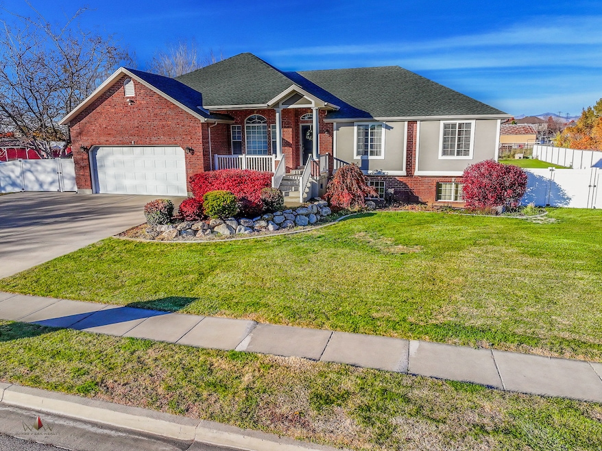 View of front of home with a porch, brick siding, driveway, roof with shingles, and a garage
