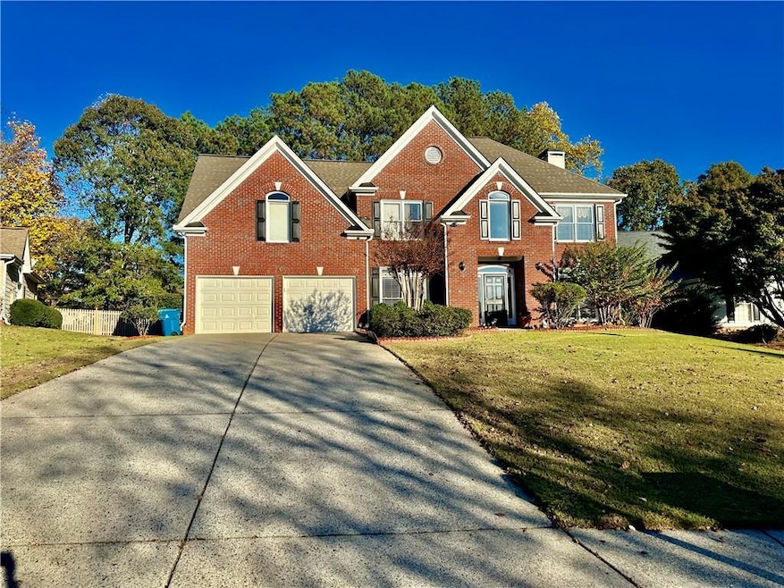 View of front of home with driveway, an attached g