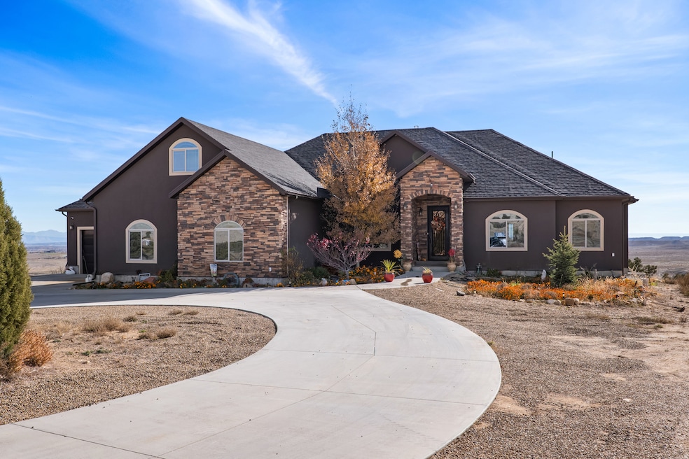 French country inspired facade featuring stone siding, stucco siding, and roof with shingles